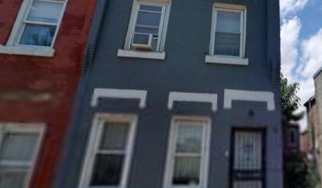 2438 N Bouvier Street, grandmother&rsquo;s house, dark navy rowhome with black storm door