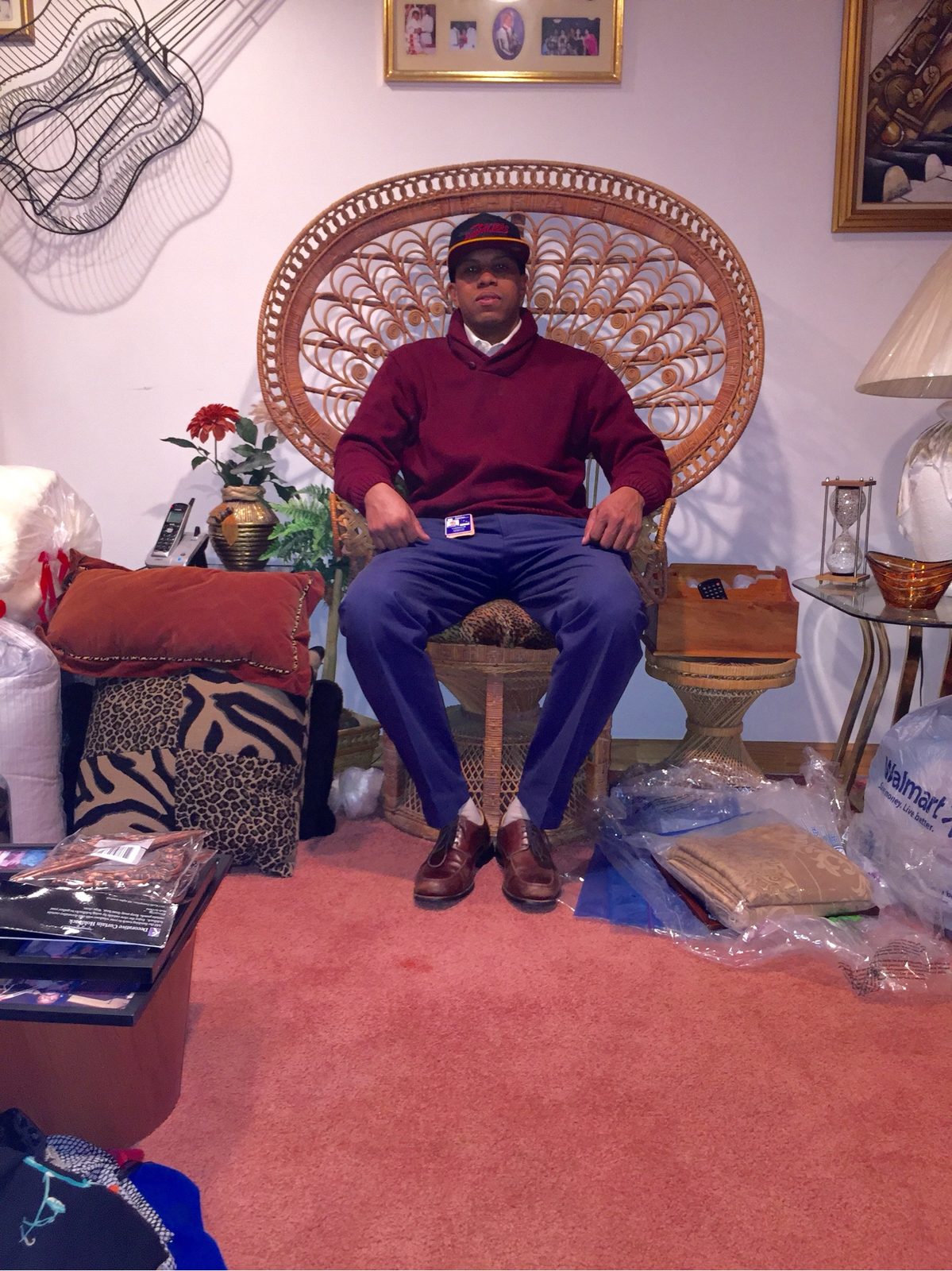 Dad in the wicker peacock chair, red room