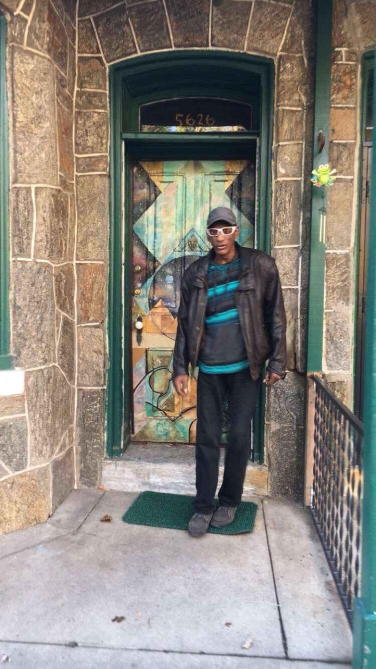 Dad standing at a painted door