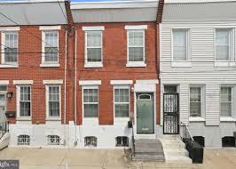 Red brick North Philadelphia rowhouse with iron security door